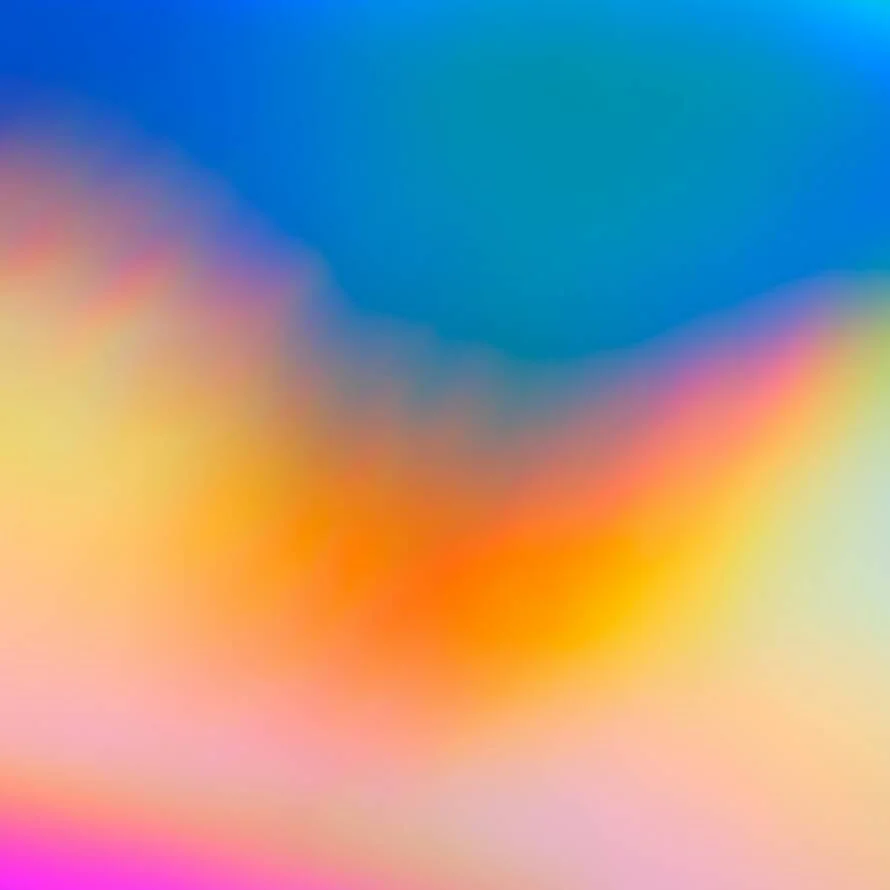 a blurry image of a rainbow colored background